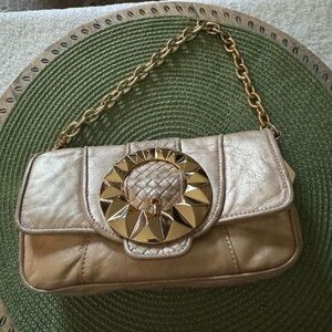 Betsey Johnson Metallic Gold Shoulder Bag with Sunburst Medallion Accent